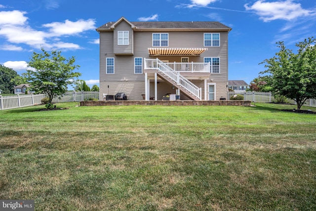 back of property featuring a lawn, stairs, and a fenced backyard