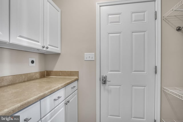 washroom with cabinet space and electric dryer hookup