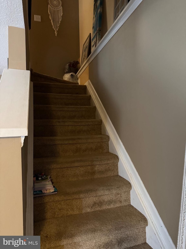 stairs featuring baseboards