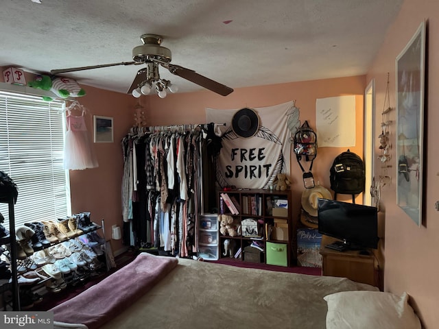 bedroom featuring a textured ceiling and a ceiling fan