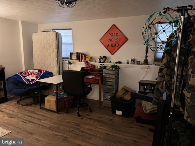 office area featuring wood finished floors and a textured ceiling