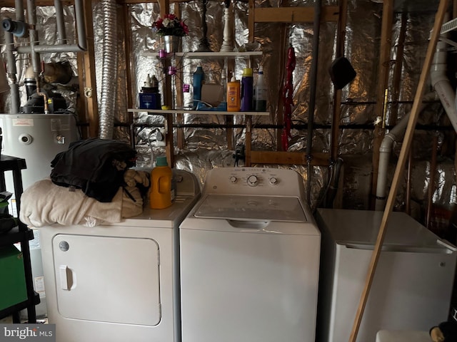 laundry room with water heater, laundry area, and separate washer and dryer