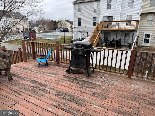 wooden terrace with grilling area and a residential view