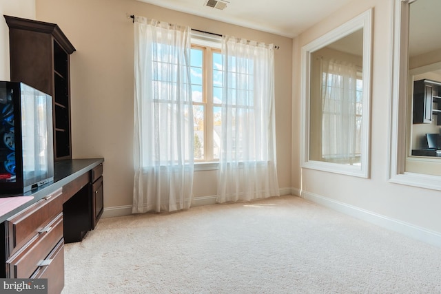 interior space featuring visible vents, light carpet, and baseboards