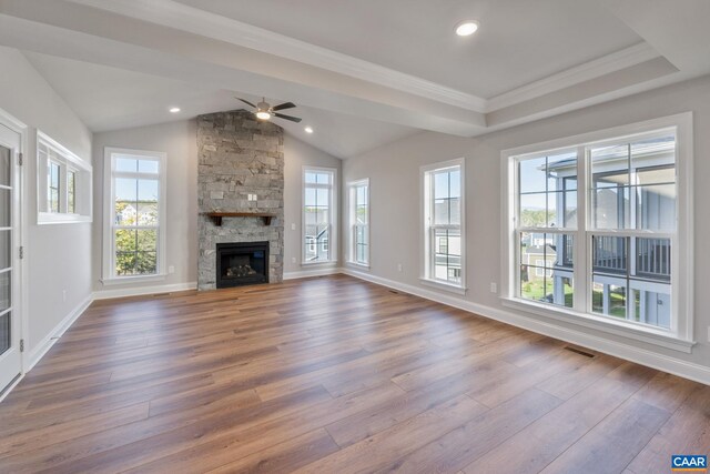 unfurnished living room with ceiling fan, plenty of natural light, lofted ceiling, and wood finished floors