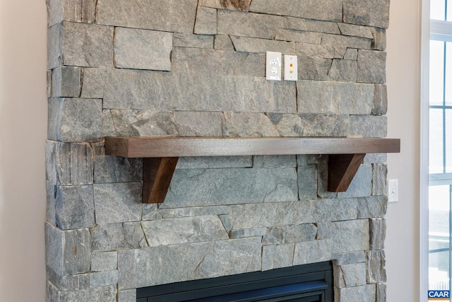 room details with a glass covered fireplace