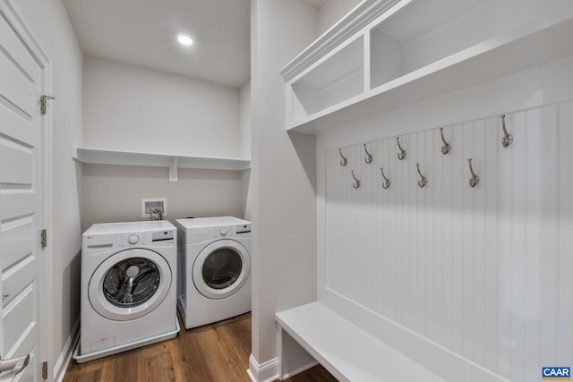 laundry room featuring recessed lighting, separate washer and dryer, wood finished floors, and laundry area