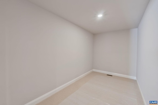 empty room with recessed lighting, visible vents, baseboards, and light colored carpet