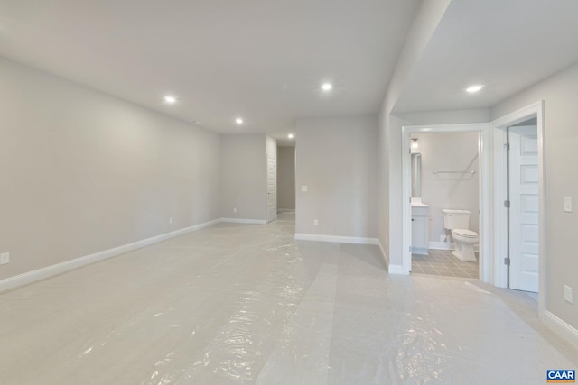 unfurnished bedroom featuring recessed lighting, connected bathroom, and baseboards