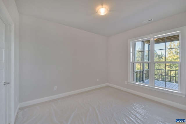 spare room featuring visible vents and baseboards