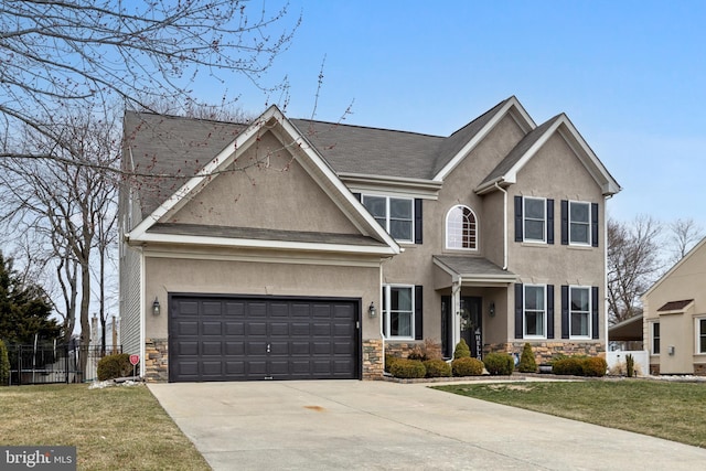 view of front facade with stucco siding, stone siding, fence, concrete driveway, and a front yard