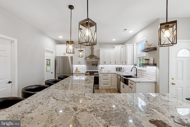 kitchen with open shelves, a sink, tasteful backsplash, stainless steel appliances, and wall chimney range hood