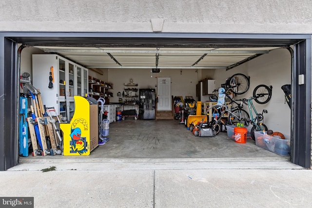 garage featuring black refrigerator with ice dispenser