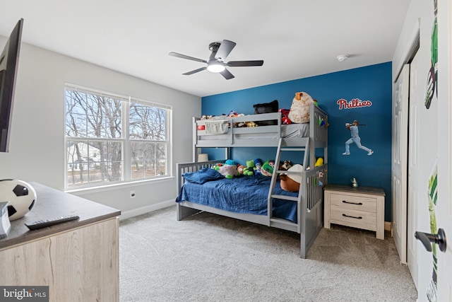 bedroom with baseboards, carpet floors, and a ceiling fan