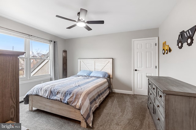 bedroom featuring dark carpet, baseboards, and ceiling fan