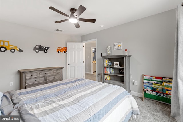 carpeted bedroom with visible vents, baseboards, and ceiling fan