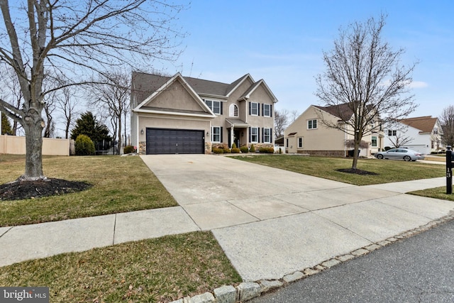 traditional-style house featuring stucco siding, an attached garage, concrete driveway, and a front lawn