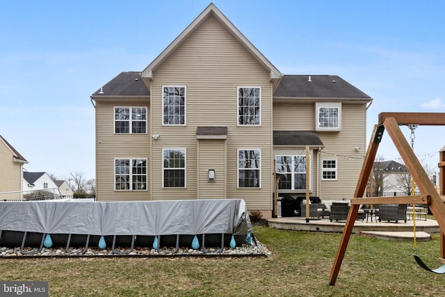 rear view of house with a patio area, a yard, and fence