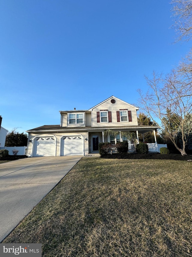 traditional-style house with a porch, an attached garage, a front yard, and driveway