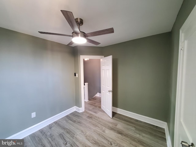 unfurnished bedroom with baseboards, light wood-style flooring, and a ceiling fan