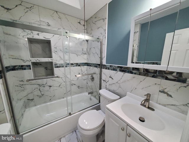 bathroom with vanity, toilet, marble finish floor, and enclosed tub / shower combo