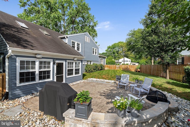 view of patio / terrace with a fire pit, a grill, and a fenced backyard