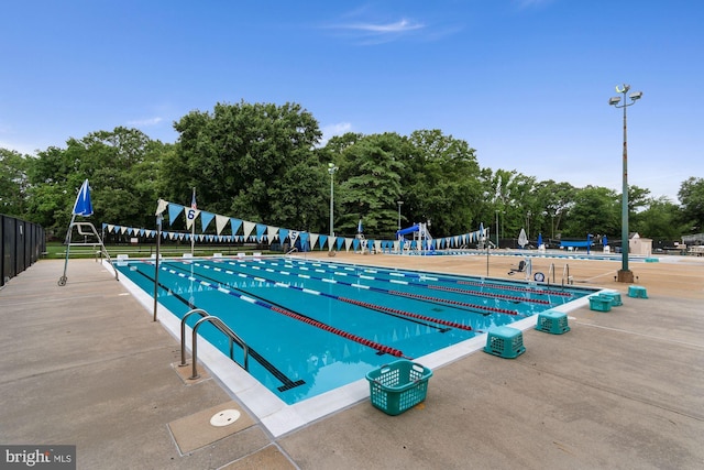 view of swimming pool with fence