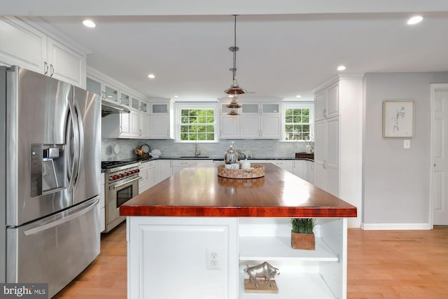 kitchen featuring butcher block countertops, appliances with stainless steel finishes, and white cabinetry