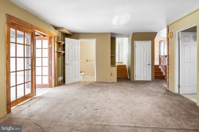 unfurnished bedroom featuring carpet and ensuite bath