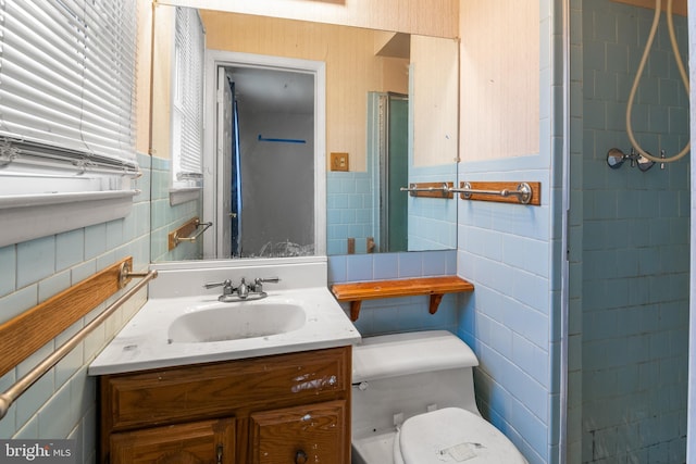 full bath with vanity, tile walls, and toilet