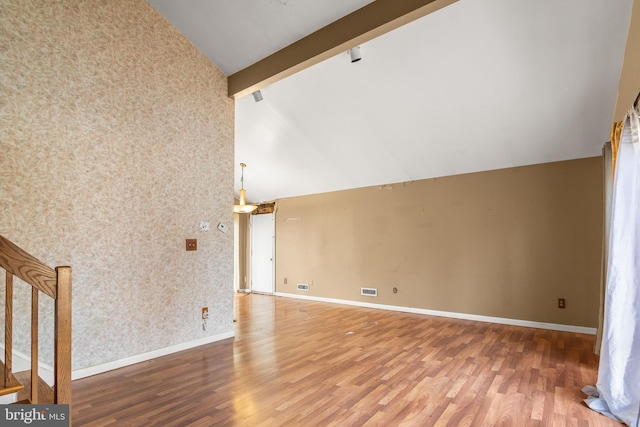 interior space with wood finished floors, baseboards, high vaulted ceiling, wallpapered walls, and beamed ceiling