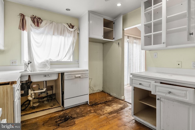 laundry area with hardwood / wood-style flooring, a healthy amount of sunlight, and a sink