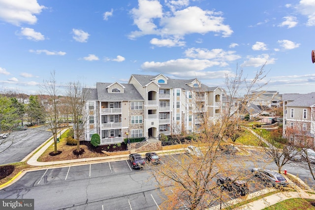 view of property featuring uncovered parking