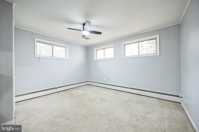 empty room featuring carpet flooring, crown molding, baseboards, and a baseboard radiator