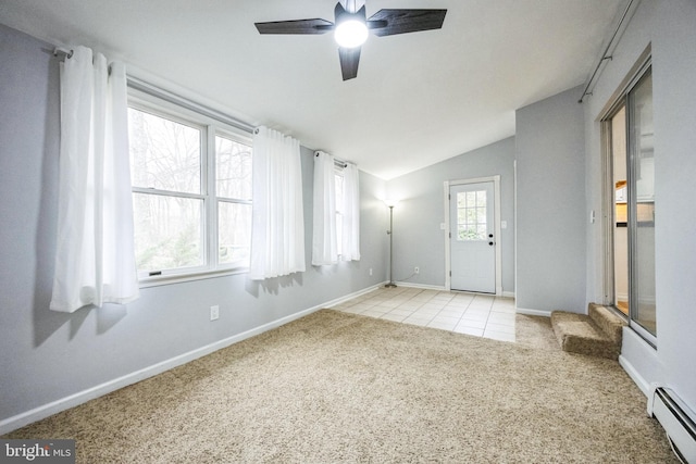 foyer featuring light tile patterned floors, lofted ceiling, ceiling fan, light carpet, and baseboard heating