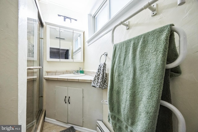 bathroom with tile patterned floors, visible vents, a stall shower, and vanity