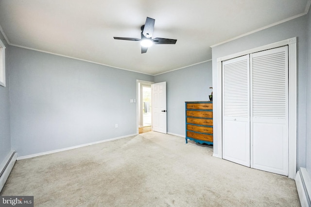 unfurnished bedroom featuring carpet, a closet, baseboard heating, and ornamental molding