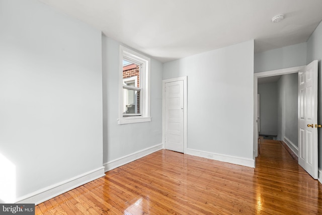 interior space with baseboards and light wood-style flooring