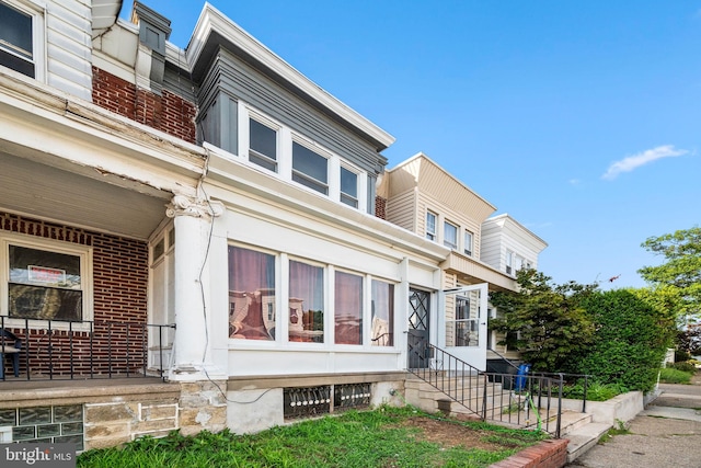 view of front of home featuring brick siding