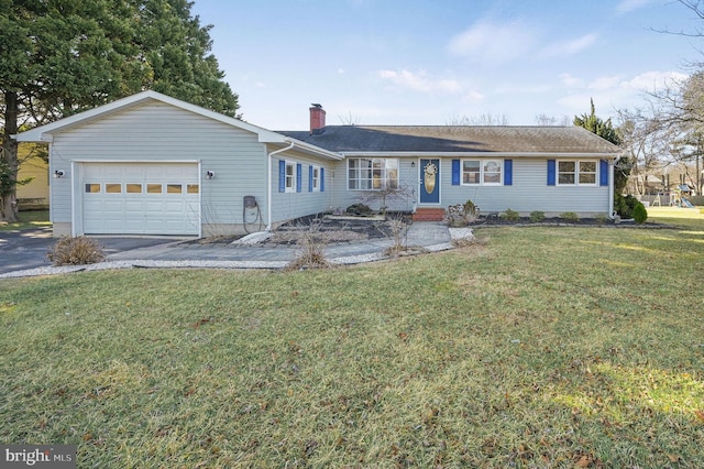 ranch-style home with an attached garage, a chimney, driveway, and a front yard