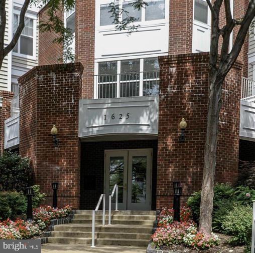 property entrance with brick siding and french doors