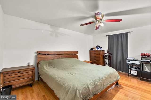 bedroom with a ceiling fan and wood finished floors