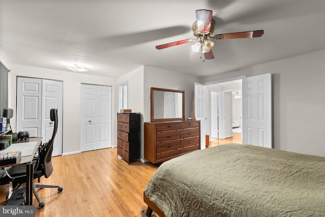 bedroom with light wood-type flooring, multiple closets, baseboards, and ceiling fan