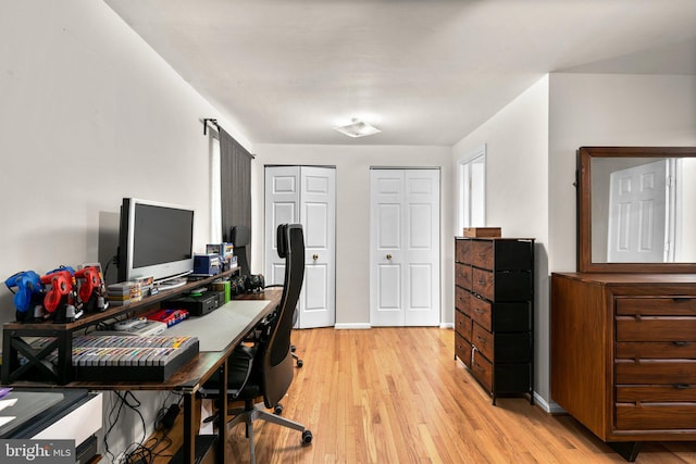 office area featuring baseboards and light wood-style floors