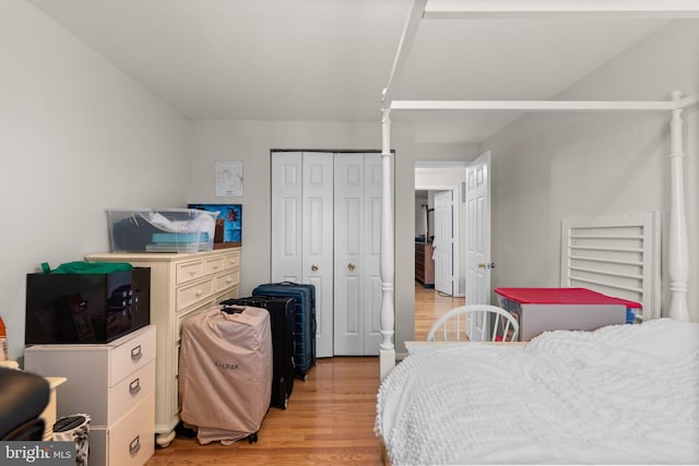 bedroom featuring a closet and light wood-style floors