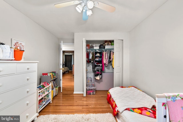 bedroom with ceiling fan, a closet, and light wood-style flooring