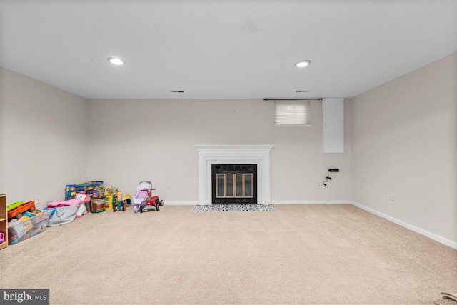 recreation room with visible vents, a fireplace with flush hearth, recessed lighting, carpet flooring, and baseboards