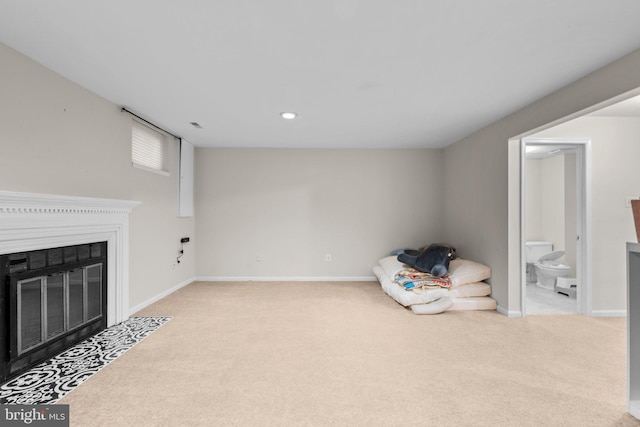 interior space featuring recessed lighting, baseboards, a fireplace with flush hearth, and carpet flooring