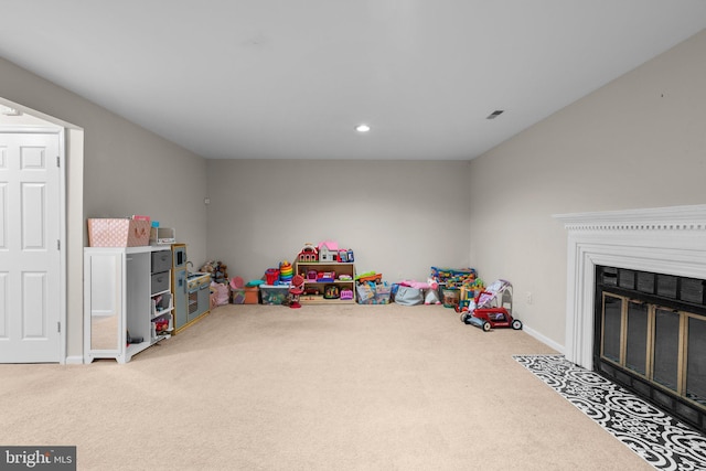 game room featuring a fireplace with flush hearth, recessed lighting, visible vents, and carpet floors