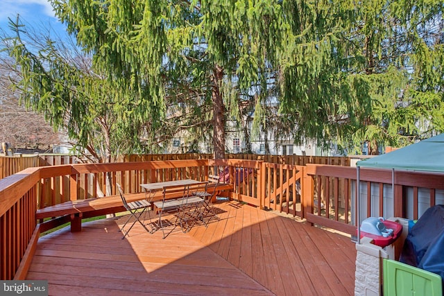 wooden deck featuring outdoor dining area and fence